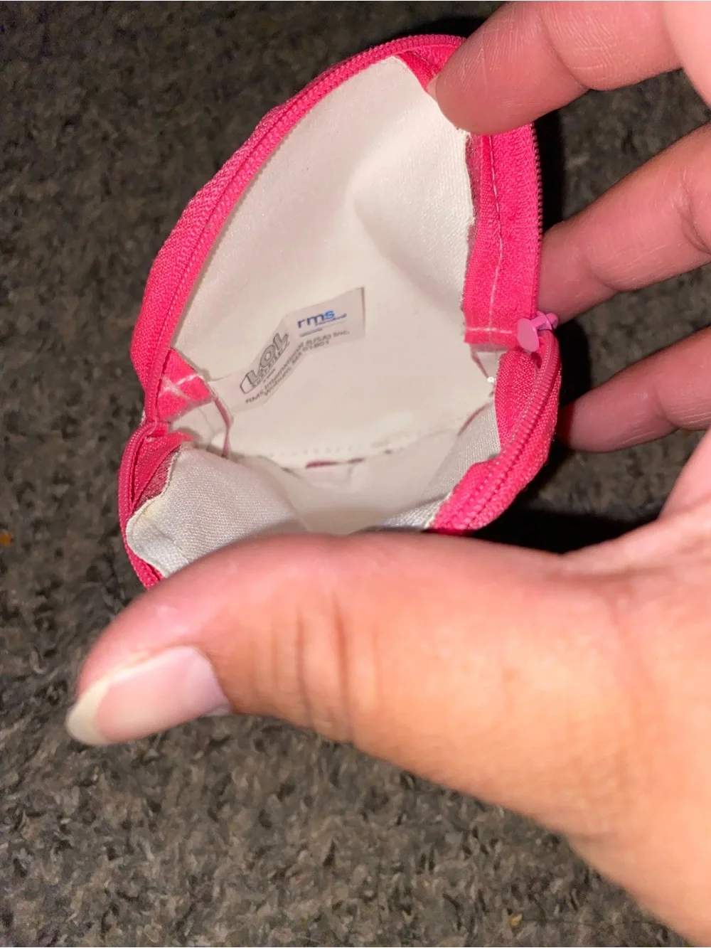 Pink glitter coin purse feature an L.O.L surprise